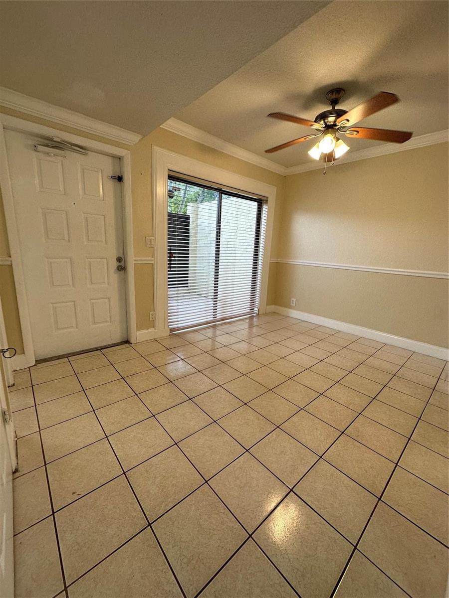 A dining area features beige walls, a white door, tiled floors, and a ceiling fan — 22435 SW 61st Way # 124, Boca Raton FL 33428, BOCA RATON, FL