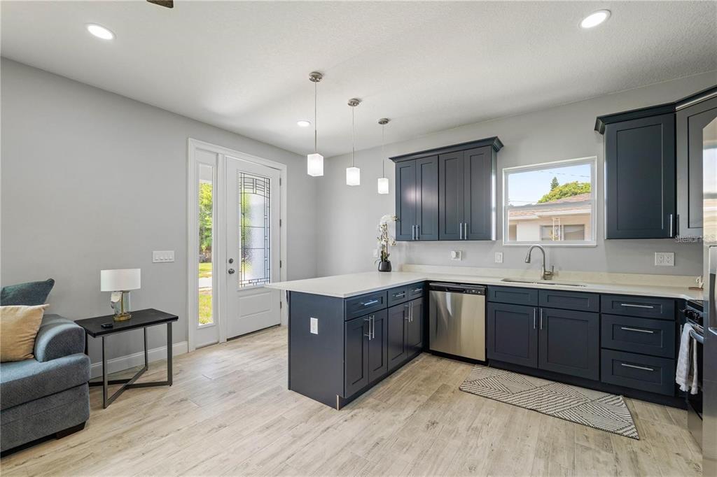 A kitchen with dark blue cabinets, white countertops, and light wood-look flooring — 2617 W SAINT JOSEPH STREET UNIT 2, TAMPA, FL
