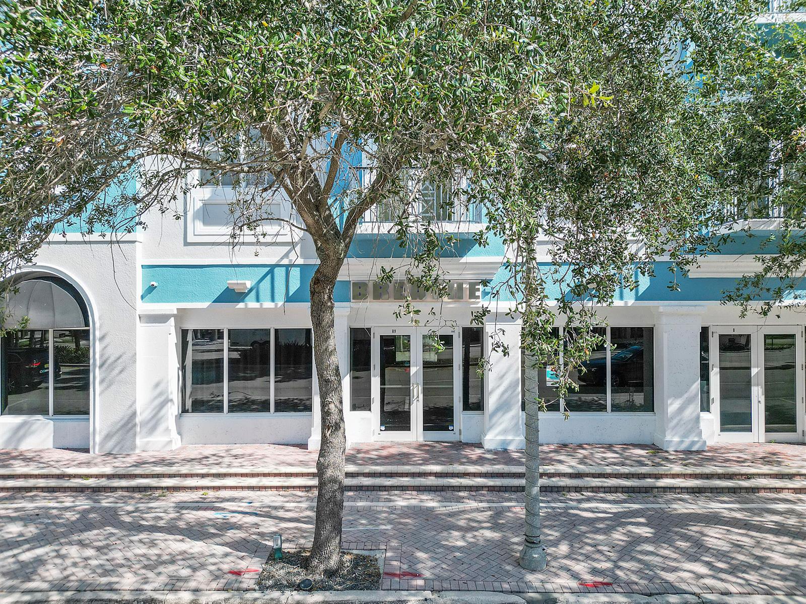 A two-story building with blue trim, large windows, and a tree in the foreground — 401 W Atlantic Avenue # R9, Delray Beach FL 33444, DELRAY BEACH, FL