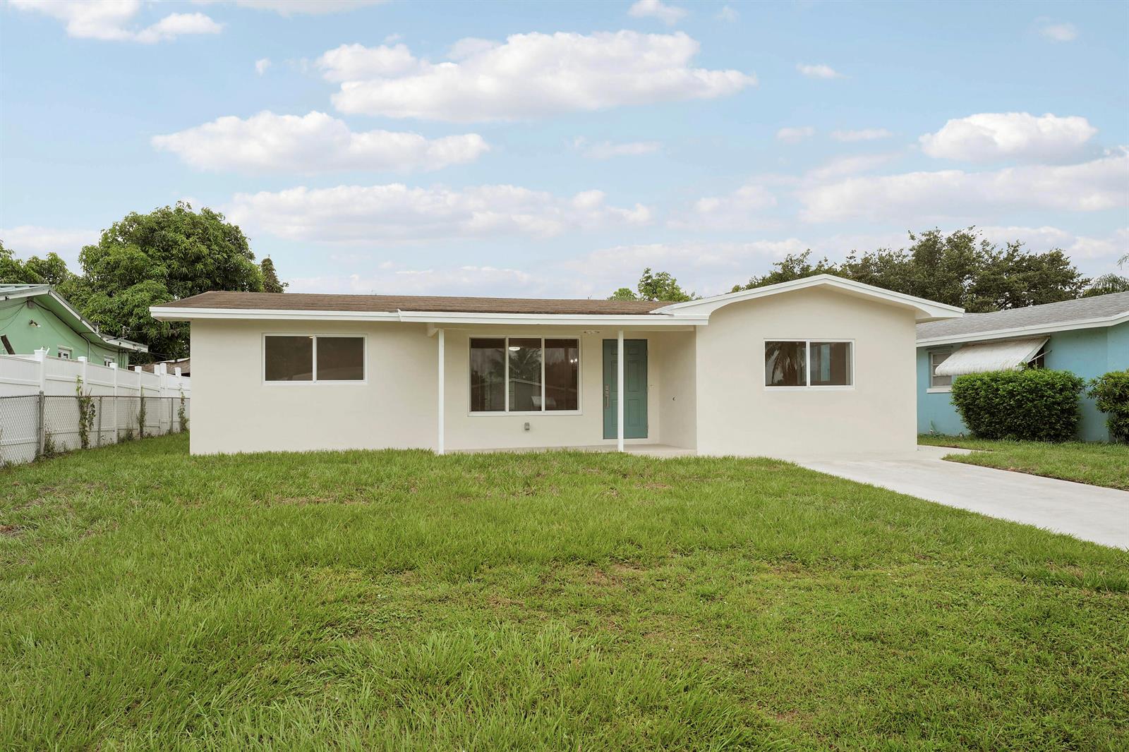 A single-story house with a beige exterior, a front porch, and a concrete driveway — 4142 Kirkland Lane, Lake Worth FL 33461, LAKE WORTH, FL