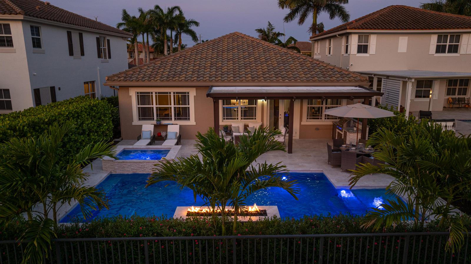An aerial view of a backyard featuring a swimming pool, hot tub, and fire feature — 9131 Cattail Run, Parkland FL 33076, PARKLAND, FL