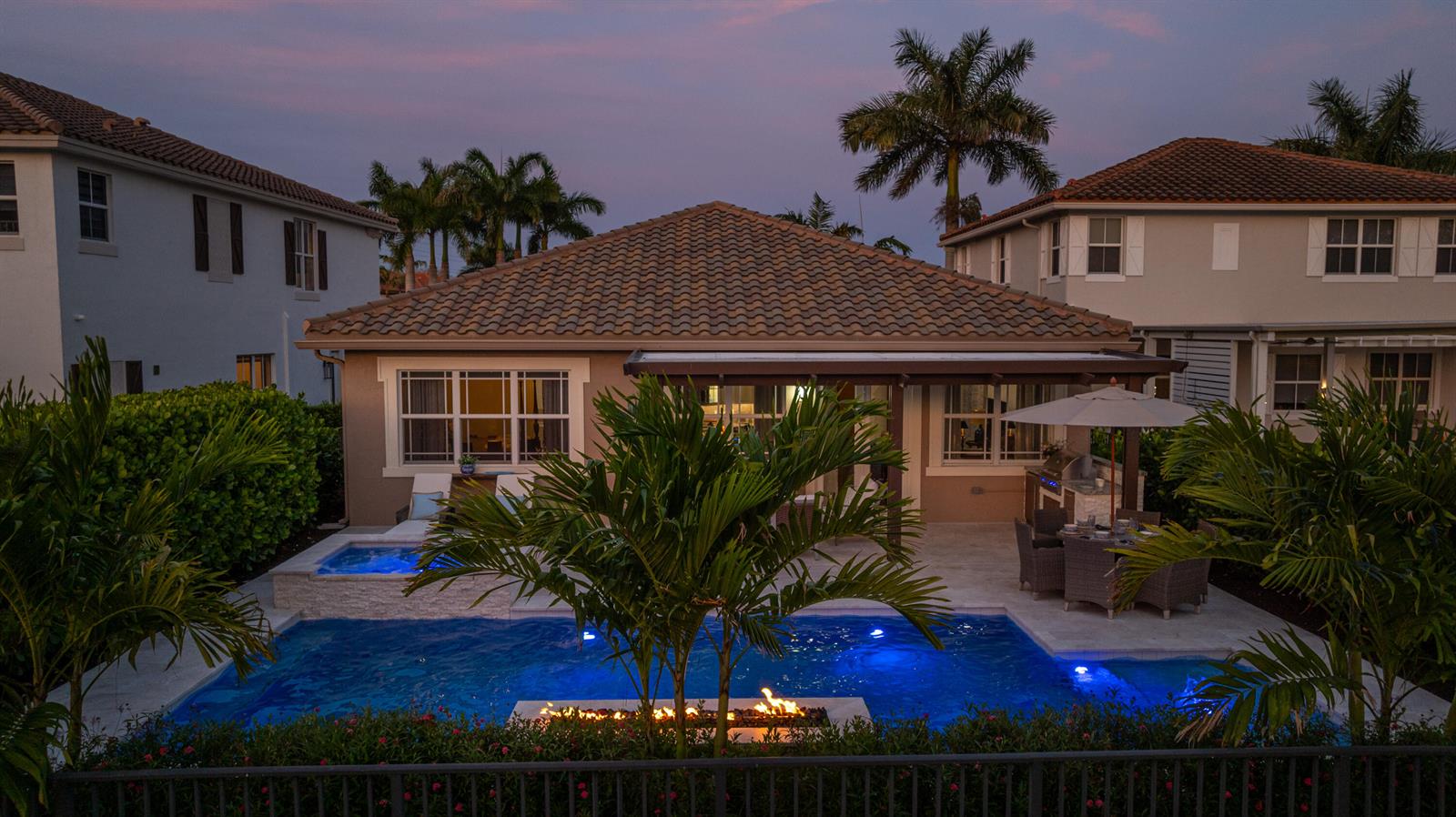 A backyard features a swimming pool, a hot tub, a fire pit, and a patio — 9131 Cattail Run, Parkland FL 33076, PARKLAND, FL