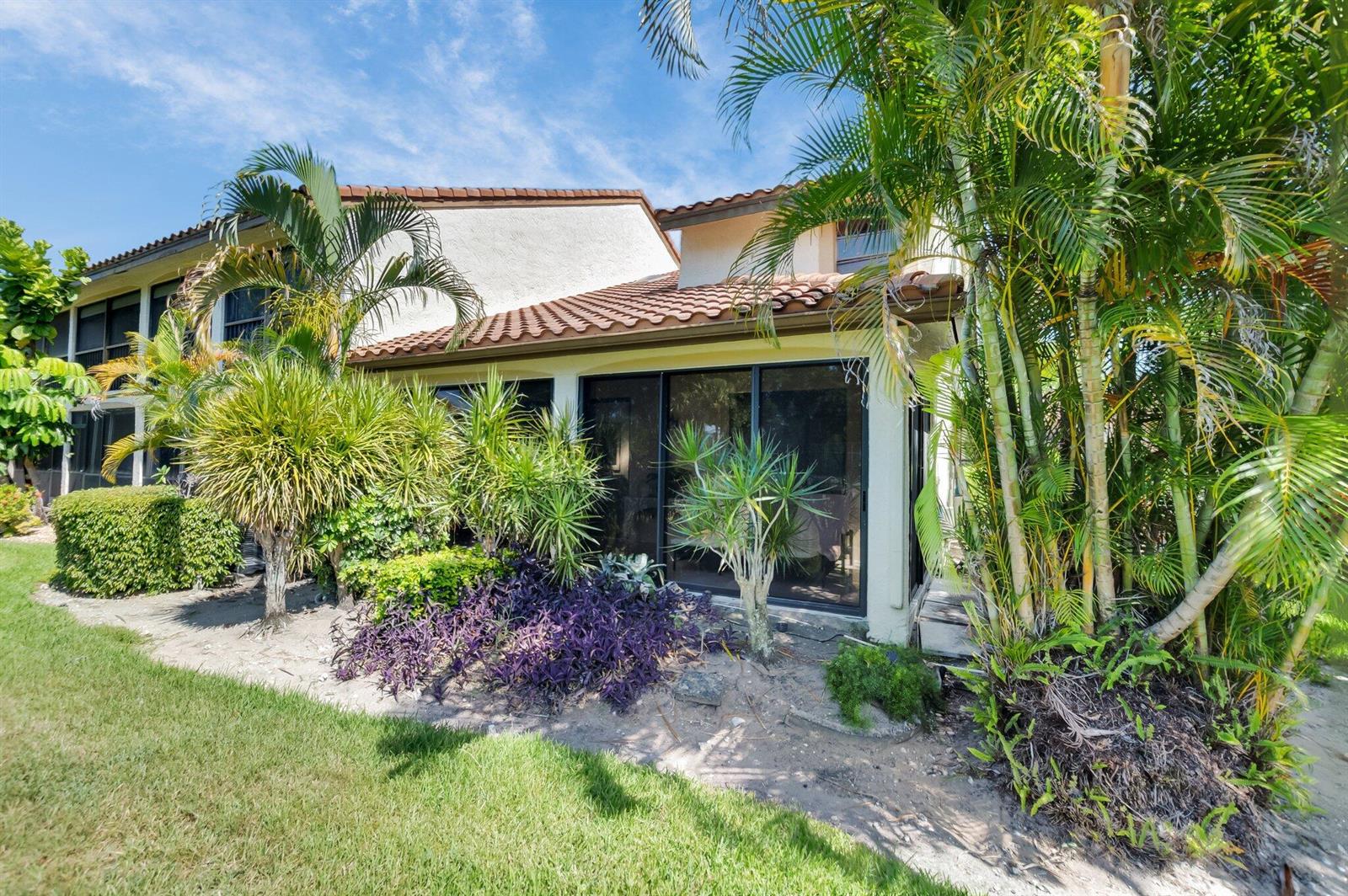A two-story stucco building with a tiled roof features a ground-floor screened-in patio area — 7940 La Mirada Drive, Boca Raton FL 33433, BOCA RATON, FL
