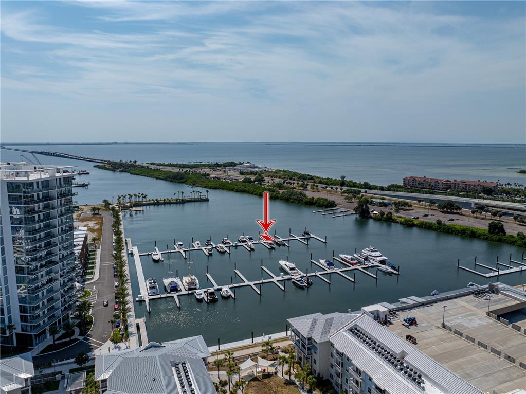 An aerial view shows a marina with multiple boat slips and a red arrow — 5120 MARINA WAY UNIT D-W-15, TAMPA, FL