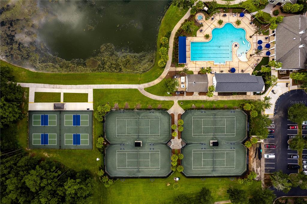 An aerial view shows a community pool, four tennis courts, and a small lake — 5995 CREEK RIDGE ROAD, BROOKSVILLE, FL