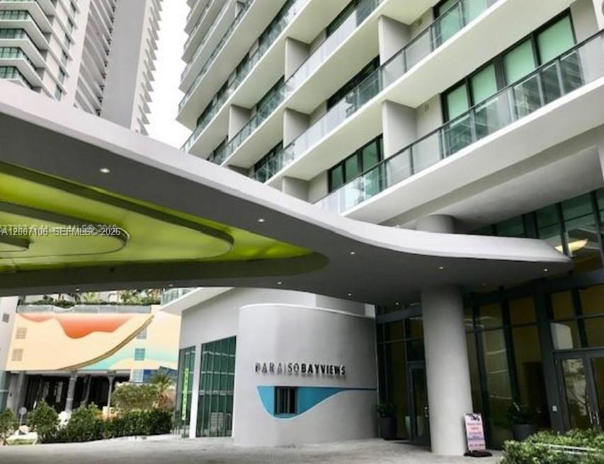 The exterior entrance of the Paraiso Bayviews high-rise building features a large, modern curved canopy — 501 NE 31st St # 910, Miami FL 33137, MIAMI, FL