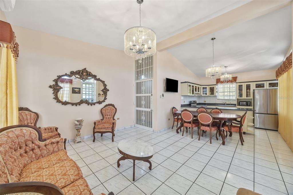 A living and dining area with tile floors, chandeliers, ornate furniture, and an open kitchen — SR 301 Km. 3.2 Interior BOQUERON, CABO ROJO, PR