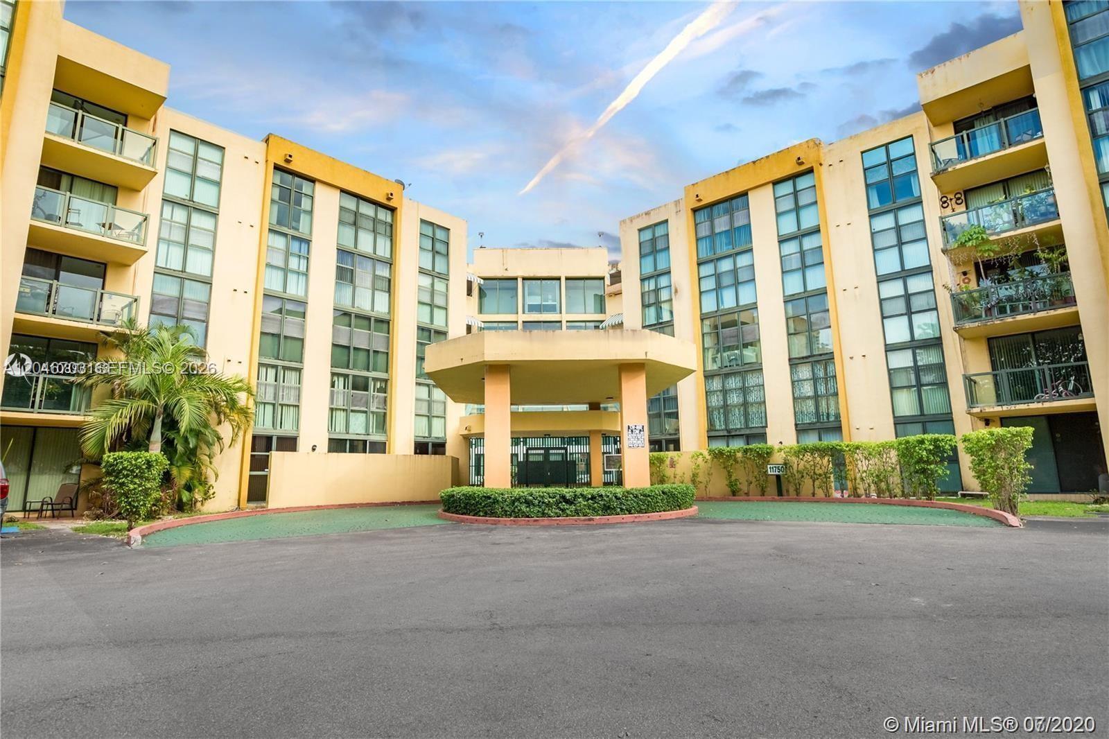 A multi-story apartment building features a central covered entrance and a paved circular driveway — 11780 SW 18th St # 2, Miami FL 33175, MIAMI, FL
