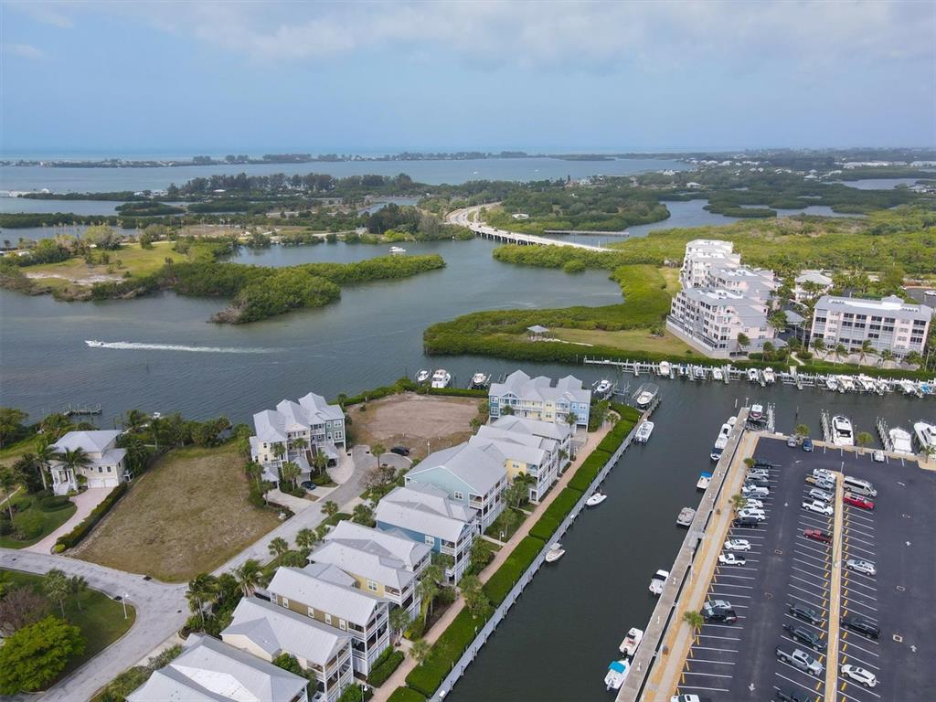 An aerial view shows a waterfront residential complex with a marina and parking lot — 11724 ANGLERS CLUB DRIVE UNIT 121, PLACIDA, FL