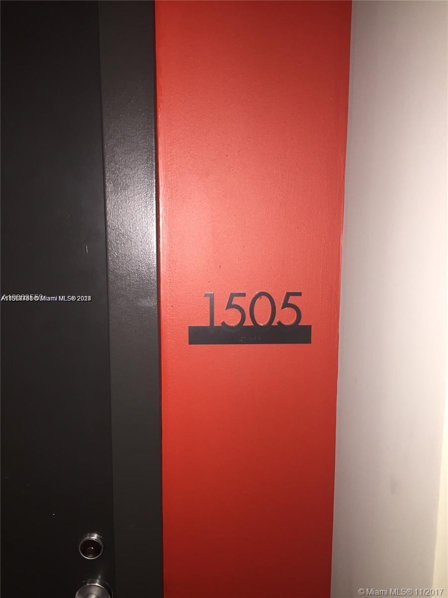 A red wall features the number 1505 in black lettering next to a dark door — 151 SE 1st St # 1505, Miami FL 33131, MIAMI, FL