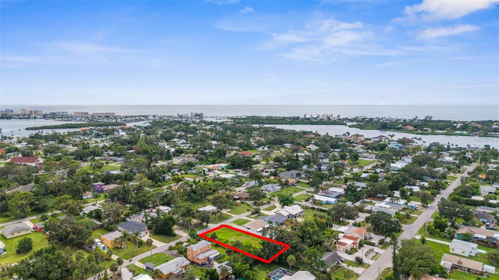 An aerial view shows a vacant rectangular lot outlined in red within a residential neighborhood — 216 PAVONIA ROAD, NOKOMIS, FL