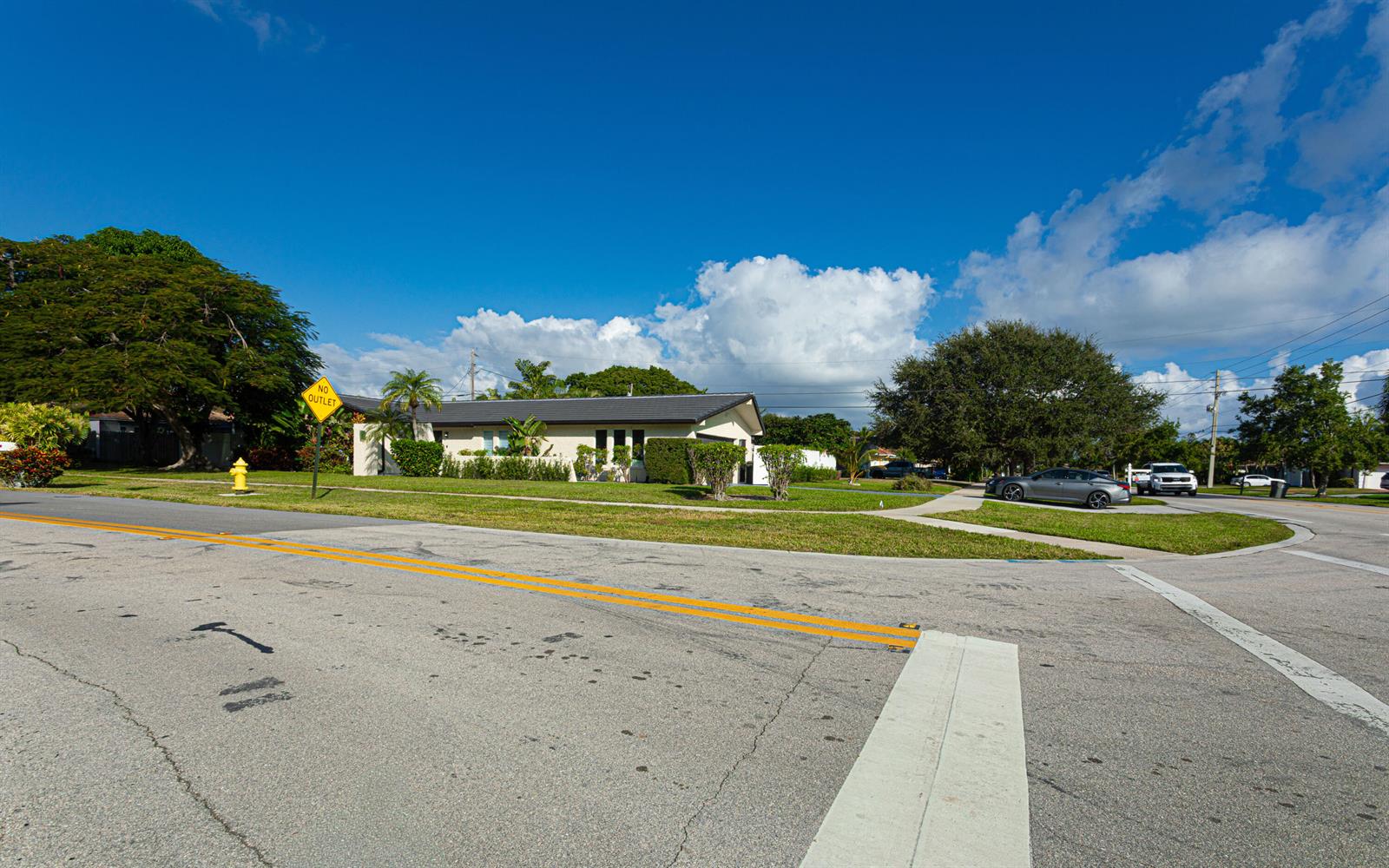 A single-story house with a dark roof sits on a corner lot with trees — 2013 Ardley Road, North Palm Beach FL 33408, NORTH PALM BEACH, FL