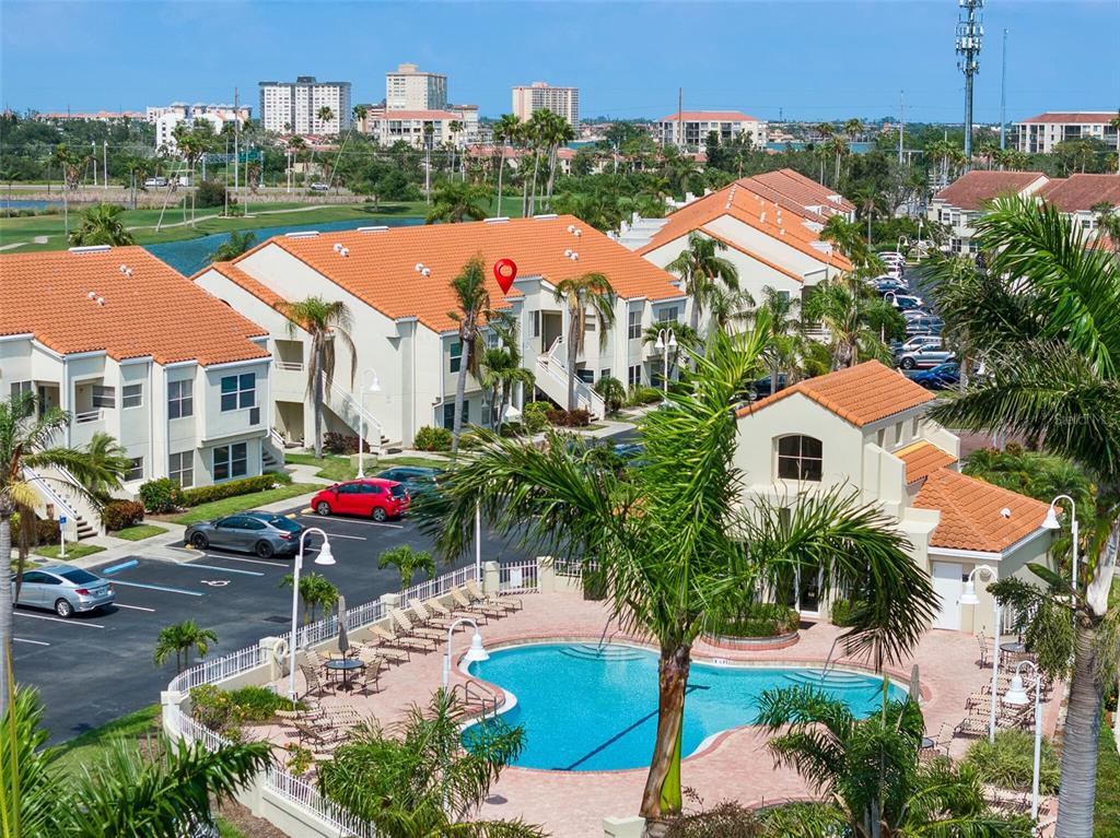 An aerial view of a multi-story apartment complex with a swimming pool and parking lot — 6171 BAHIA DEL MAR BOULEVARD UNIT 216, ST PETERSBURG, FL
