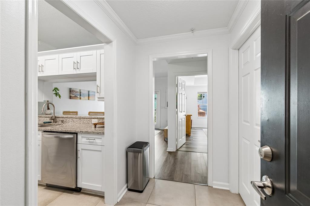 A view from a doorway looking into a kitchen and a hallway with wood flooring — 800 S DAKOTA AVENUE UNIT 237, TAMPA, FL