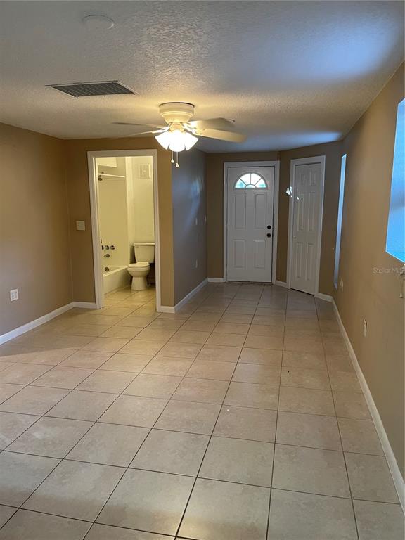 A kitchen features white appliances, dark wood cabinets, and light tile flooring — 206 OSCEOLA AVENUE, EUSTIS, FL
