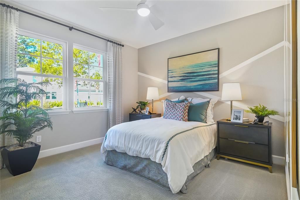 A bedroom features a bed with a white comforter, two nightstands, and a wall mural — 231 THORNBERRY WAY, PALM COAST, FL