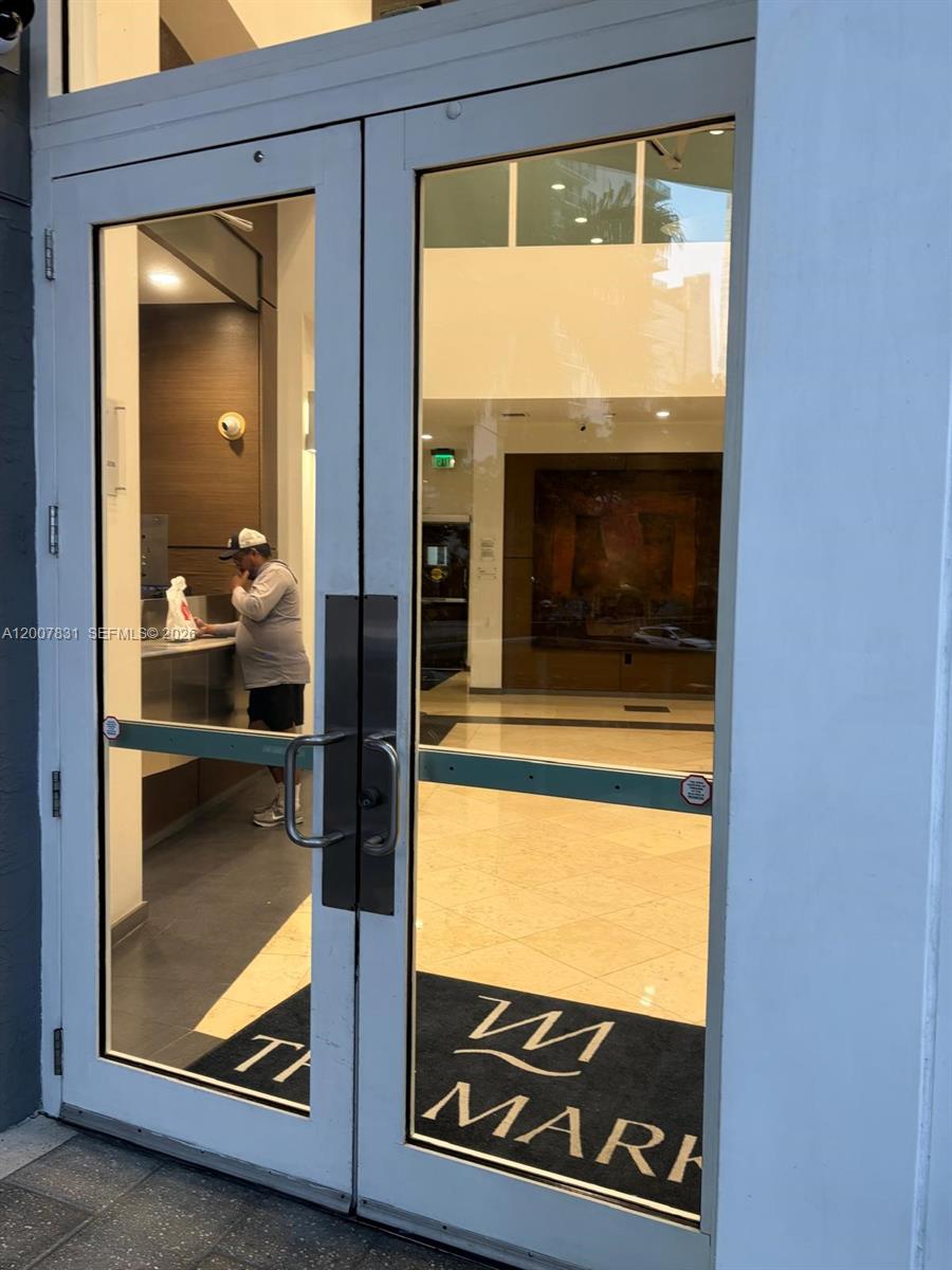 A glass double door entry leads into a building lobby with a reception desk — 1155 Brickell Bay Dr # 1201, Miami FL 33131, MIAMI, FL