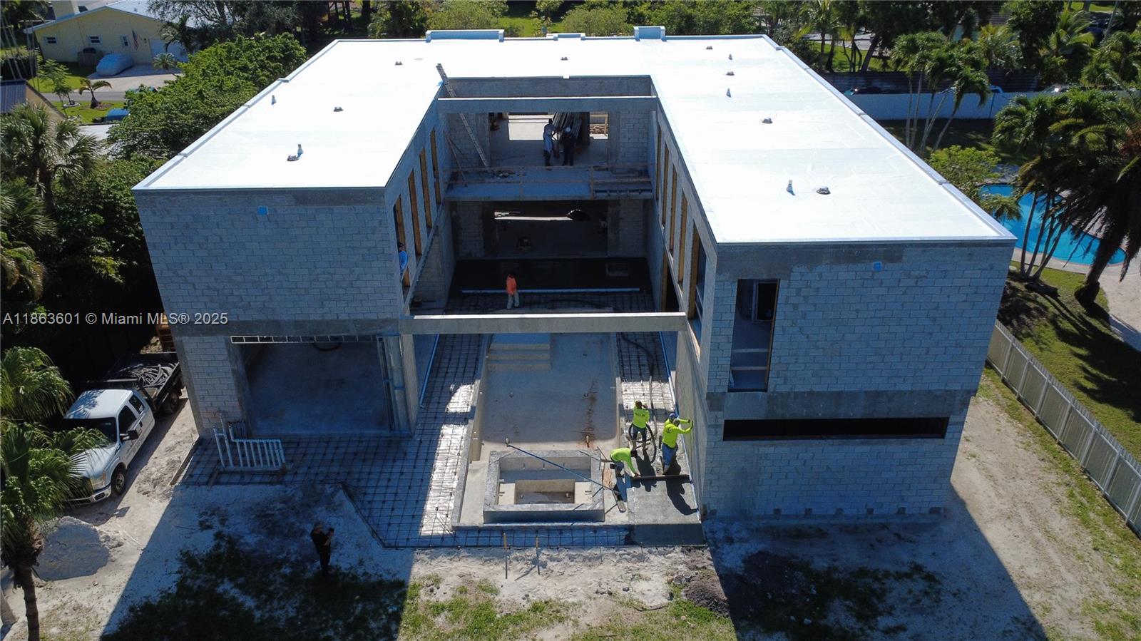 An aerial view shows a two-story concrete block house under construction with an open courtyard — 13050 SW 103 Ave, Miami FL 33176, MIAMI, FL