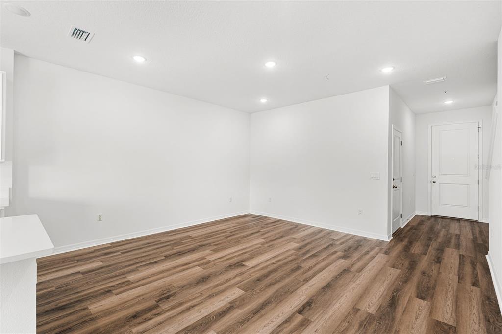 An empty room with white walls, recessed lighting, and wood-look flooring — 4905 WINDING RIVER ROAD, ORLANDO, FL