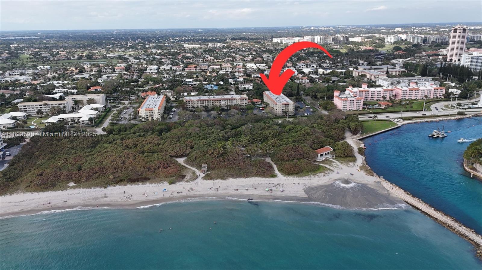 An aerial view shows a multi-story residential building near a sandy beach and ocean — 950 Ponce De Leon Rd # 2100, Boca Raton FL 33432, BOCA RATON, FL