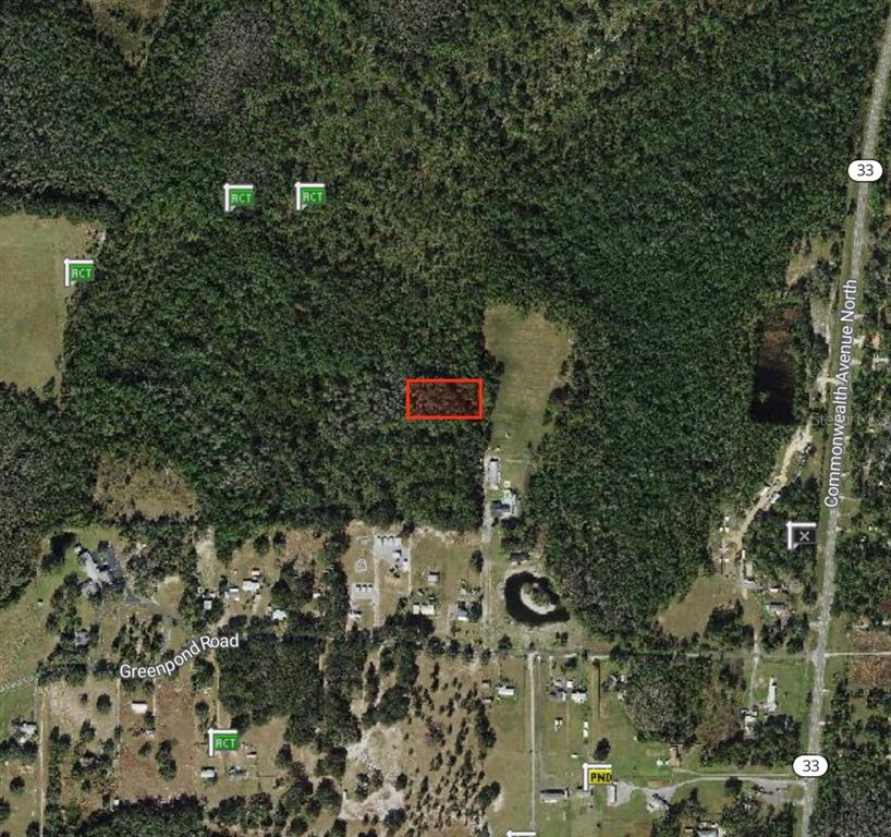 This aerial map shows a rectangular plot of land highlighted in red within a wooded area — POLK CITY, POLK CITY, FL