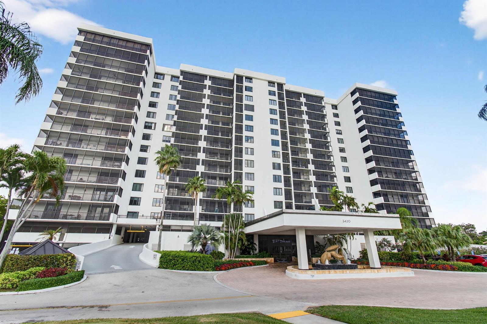 A multi-story white apartment building with balconies and a covered entrance driveway — 3420 S Ocean Boulevard # 5z, Highland Beach FL 33487, HIGHLAND BEACH, FL