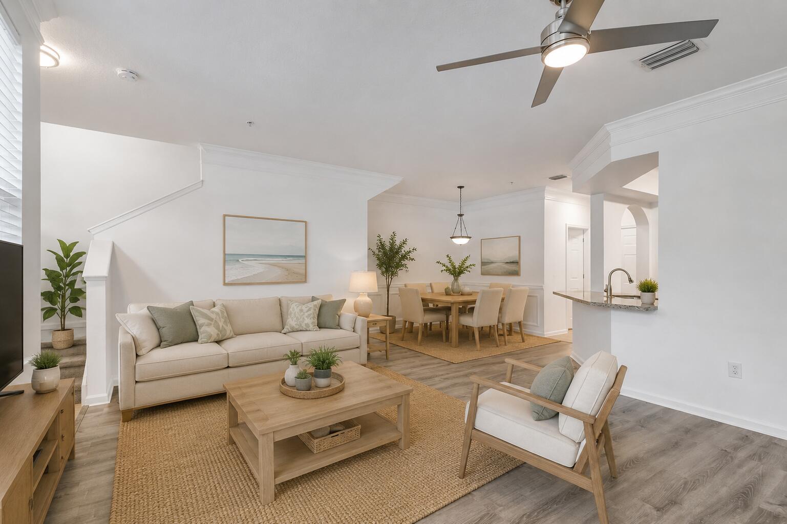 An open-concept living and dining area features light wood floors, neutral furniture, and a ceiling fan — 826 Dakota Drive # 102, Jupiter FL 33458, JUPITER, FL