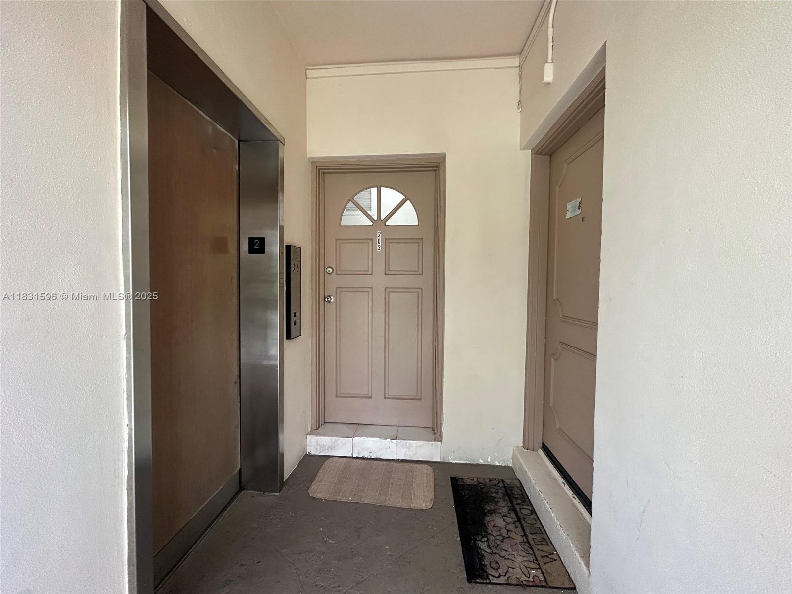 This hallway features an elevator, a central door numbered 202, and an adjacent door — 1020 94th St # 202, Bay Harbor Islands FL 33154, BAY HARBOR ISLANDS, FL