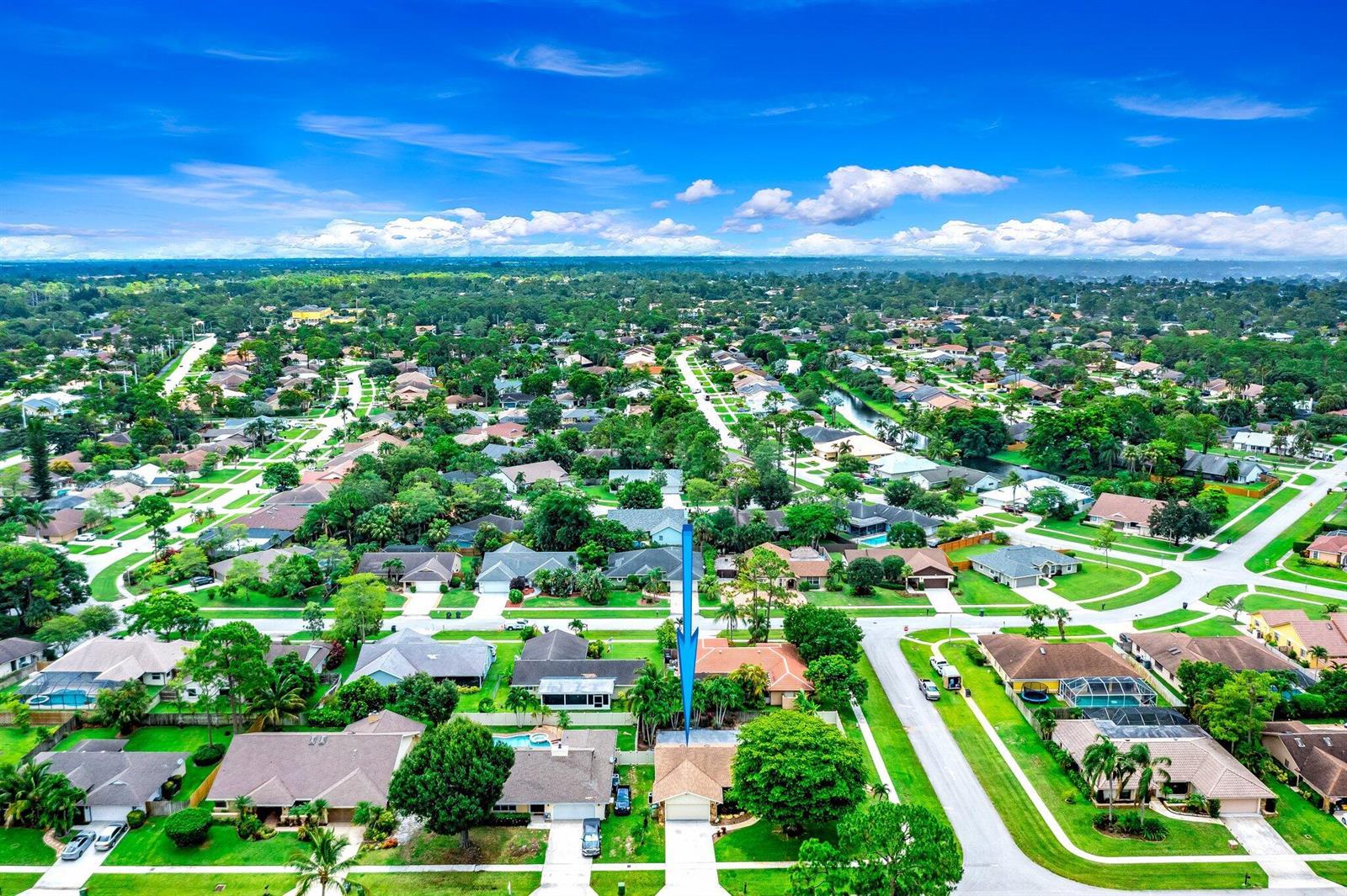An aerial view of a suburban neighborhood featuring single-family homes with green lawns and trees — 574 Juniper Place, Wellington FL 33414, WELLINGTON, FL