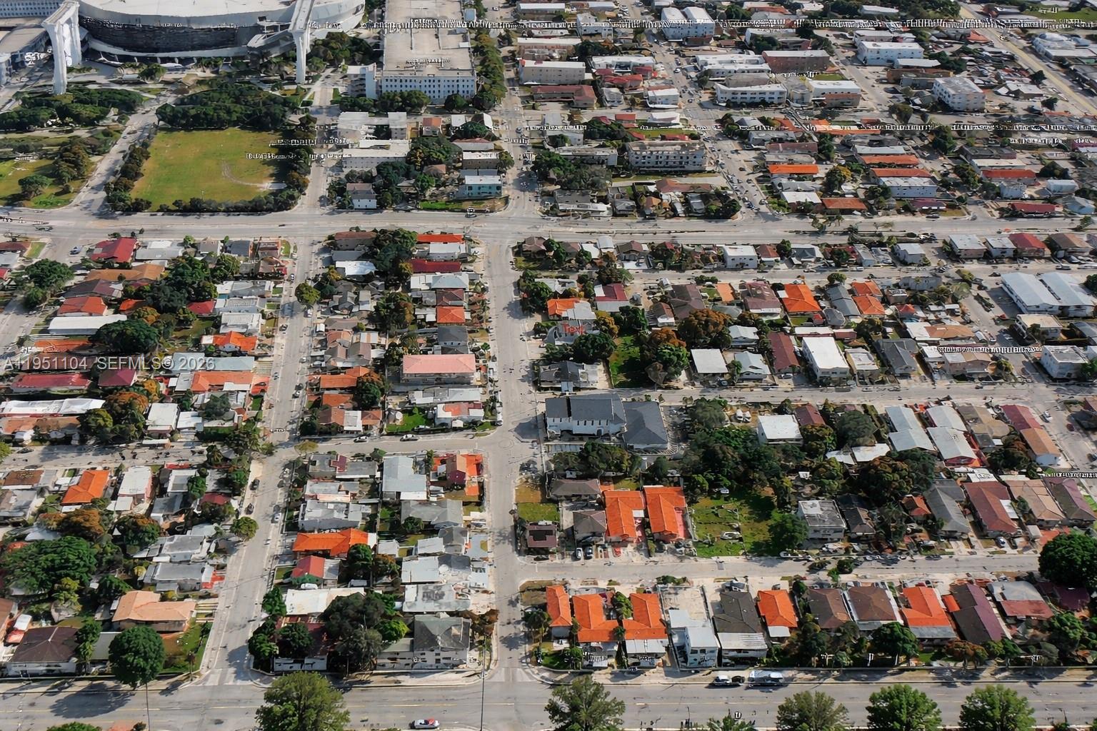 An aerial view shows a dense residential neighborhood with streets, houses, and a large stadium — 161 NW 18th Ave, Miami FL 33125, MIAMI, FL