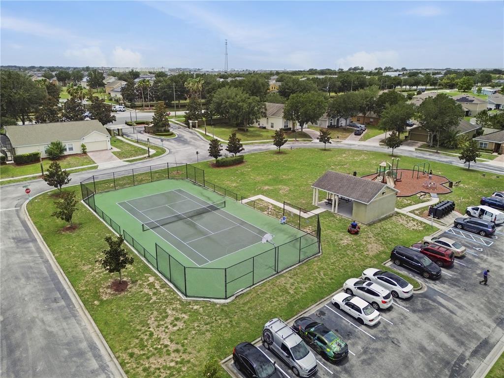 An aerial view shows a fenced tennis court, a playground, a pavilion, and a parking lot — 238 GRANADA AVENUE, DAVENPORT, FL