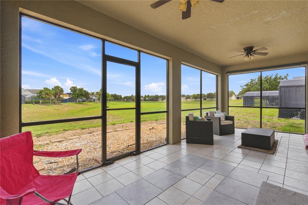 A kitchen with dark cabinets, a stone-front breakfast bar, and stainless steel appliances — 238 GRANADA AVENUE, DAVENPORT, FL