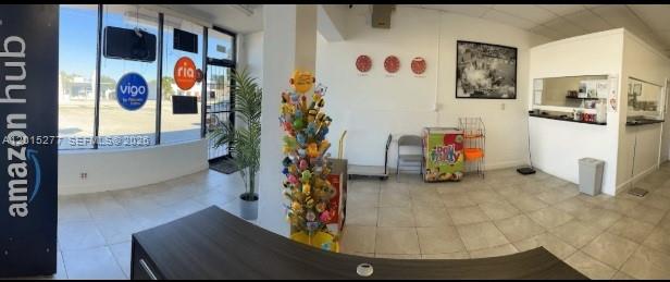 This commercial interior features a reception desk, a product display stand, and large storefront windows — Established Pack, Ship, Mailbox & Business Service, Hollywood FL 33021, HOLLYWOOD, FL