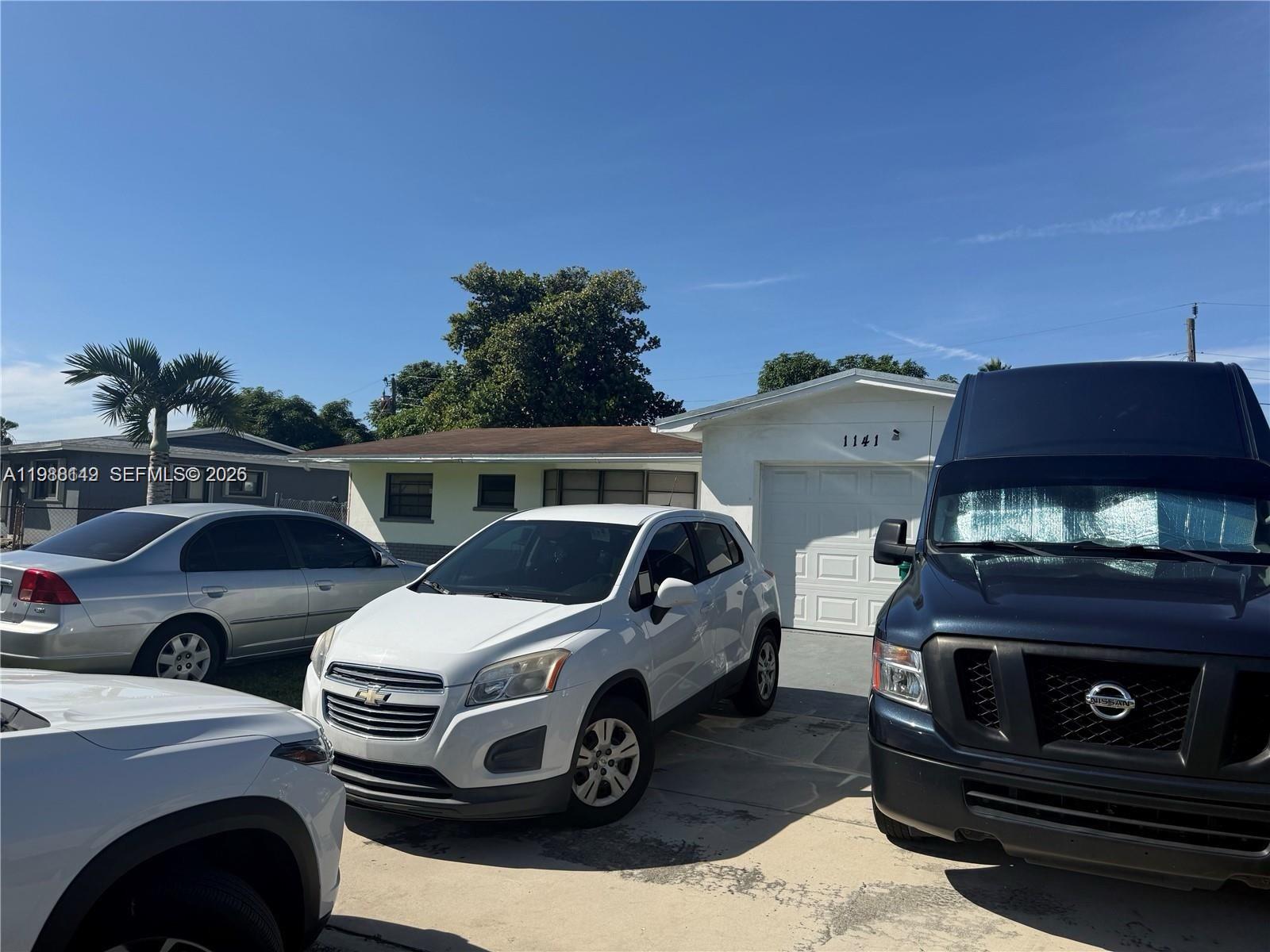 A white house with a garage and three cars parked in the driveway — 1141 NW 41st Ter, Lauderhill FL 33313, LAUDERHILL, FL