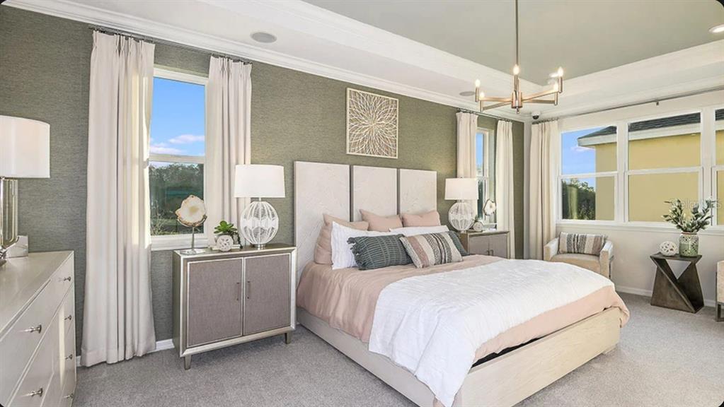 A bedroom features a textured olive green accent wall, a light-colored bed, and large windows — 5156 DOMINION ALLEY, ST CLOUD, FL