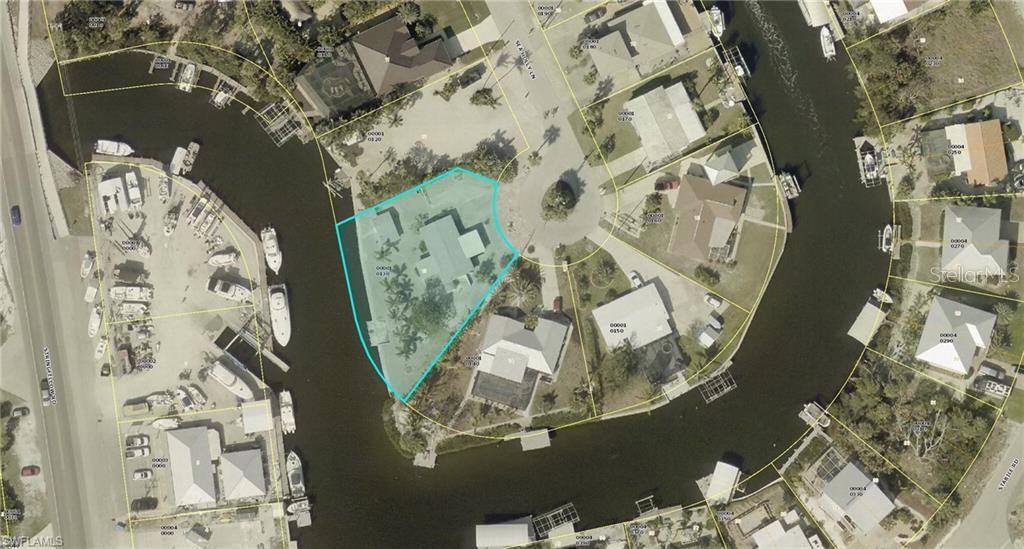 This aerial map shows a waterfront residential property highlighted in blue within a canal neighborhood — 3435 SEA HOLLY LANE, ST JAMES CITY, FL