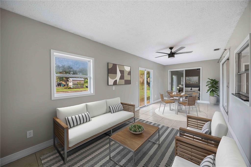 A sunroom features tile floors, a ceiling fan, a sofa, and a dining area — 19367 EDGEWATER DRIVE, PORT CHARLOTTE, FL