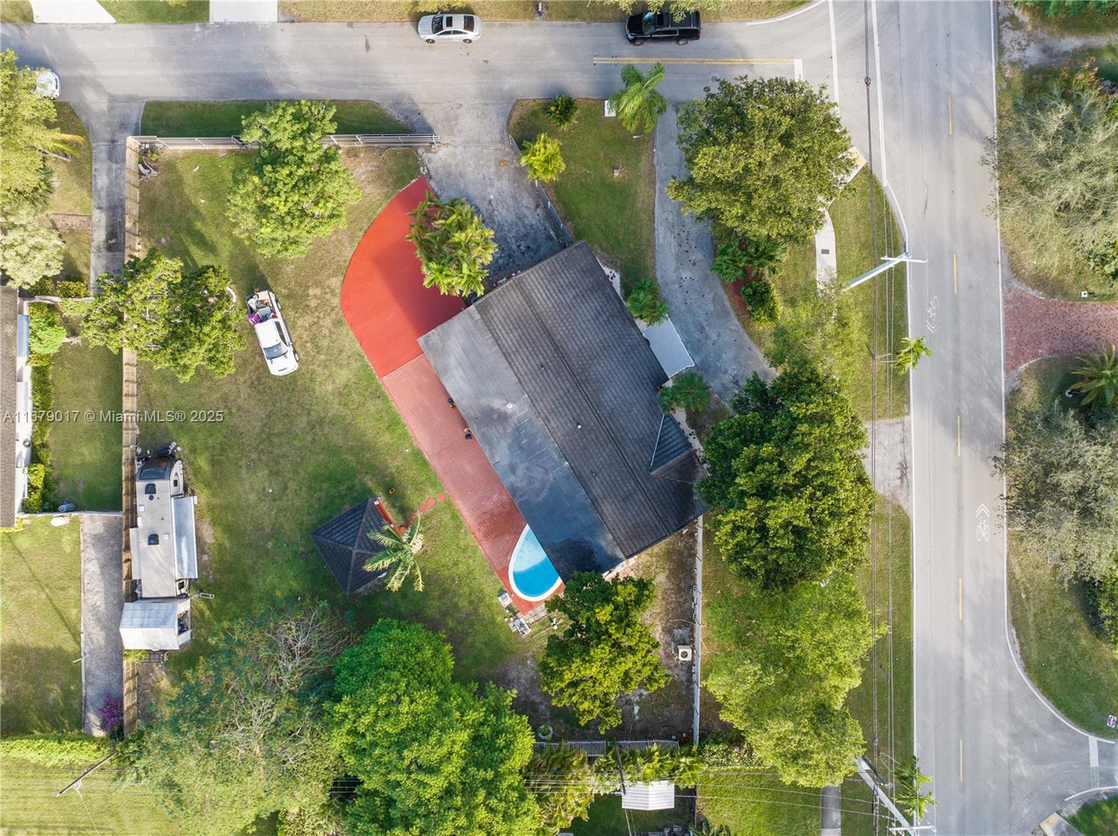 An aerial view shows a house with a pool, red patio, and a large yard — 13550 SW 99th Pl, Miami FL 33176, MIAMI, FL