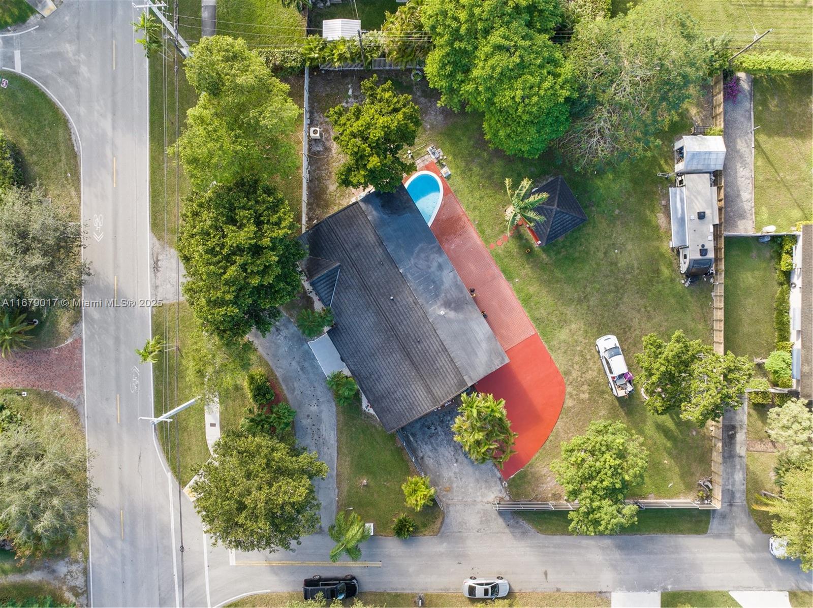 An aerial view shows a house with a pool, red patio, and a driveway — 13550 SW 99th Pl, Miami FL 33176, MIAMI, FL