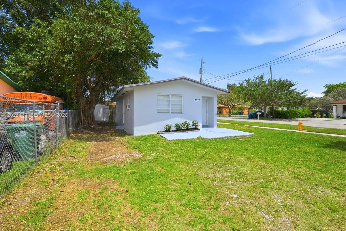 A white single-story house sits on a grassy corner lot with a sidewalk — 17875 SW 103rd Ave, Miami FL 33157, MIAMI, FL