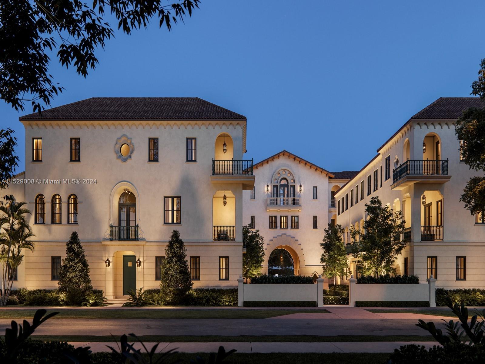 This is a rendering of a multi-story Mediterranean-style building exterior at dusk — 504 Malaga Ave # T8, Coral Gables FL 33134, CORAL GABLES, FL