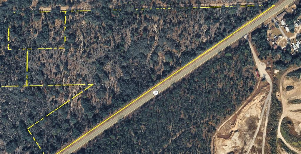 An aerial map shows a wooded plot of land outlined in yellow next to a highway — 120 NE SR24 AVENUE NE, ARCHER, FL