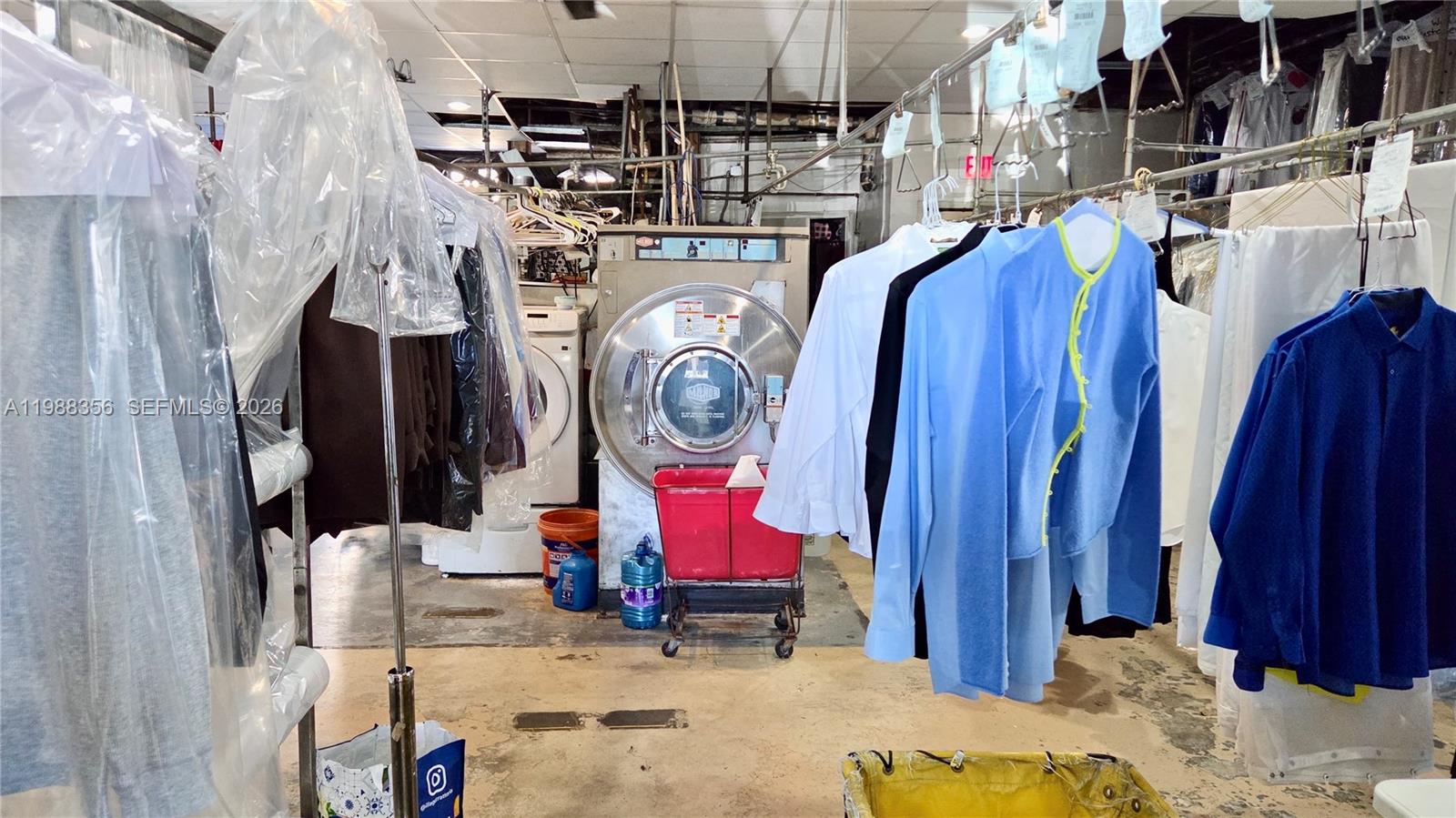 A commercial dry cleaning facility features hanging garments, industrial laundry equipment, and concrete flooring — 4222 W 16th Ave, Hialeah FL 33012, HIALEAH, FL