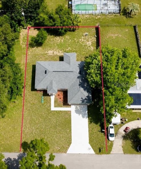 This aerial view shows a house on a lot outlined in red — 20115 SW 83RD PLACE, DUNNELLON, FL
