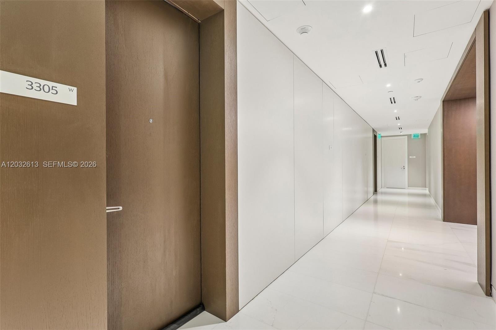 A hallway features a brown door labeled 3305, white walls, and a white tiled floor — 300 Biscayne Boulevard Way # 3305W, Miami FL 33131, MIAMI, FL