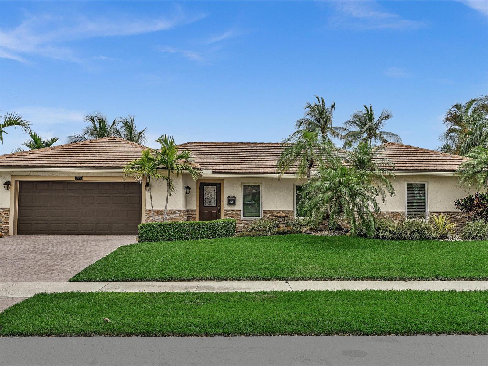 A single-story house with a brown tile roof, stone accents, and a manicured front lawn — 1525 SE 12th Street, Deerfield Beach FL 33441, DEERFIELD BEACH, FL