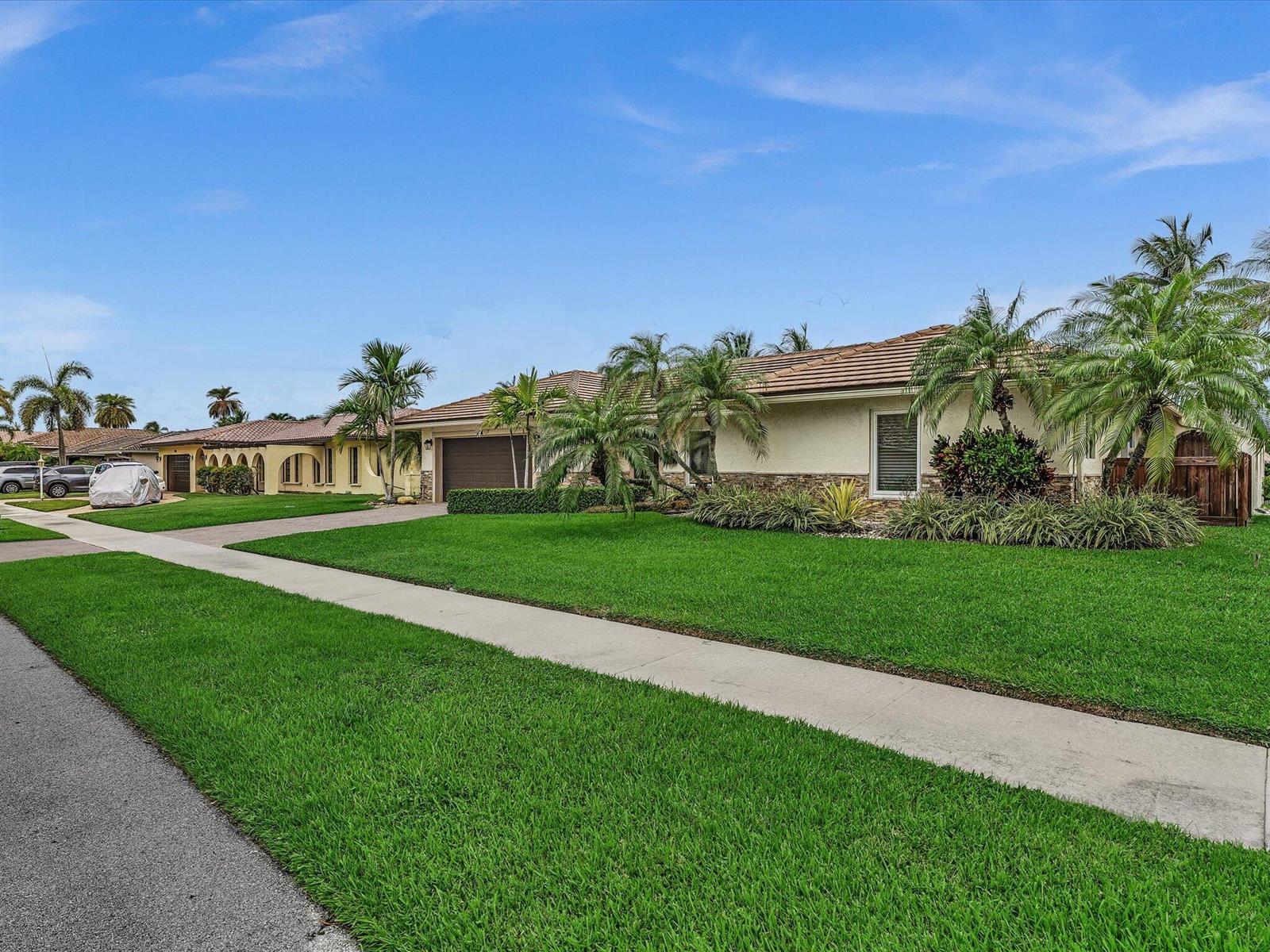A single-story suburban house with a tiled roof, palm trees, and a manicured front lawn — 1525 SE 12th Street, Deerfield Beach FL 33441, DEERFIELD BEACH, FL