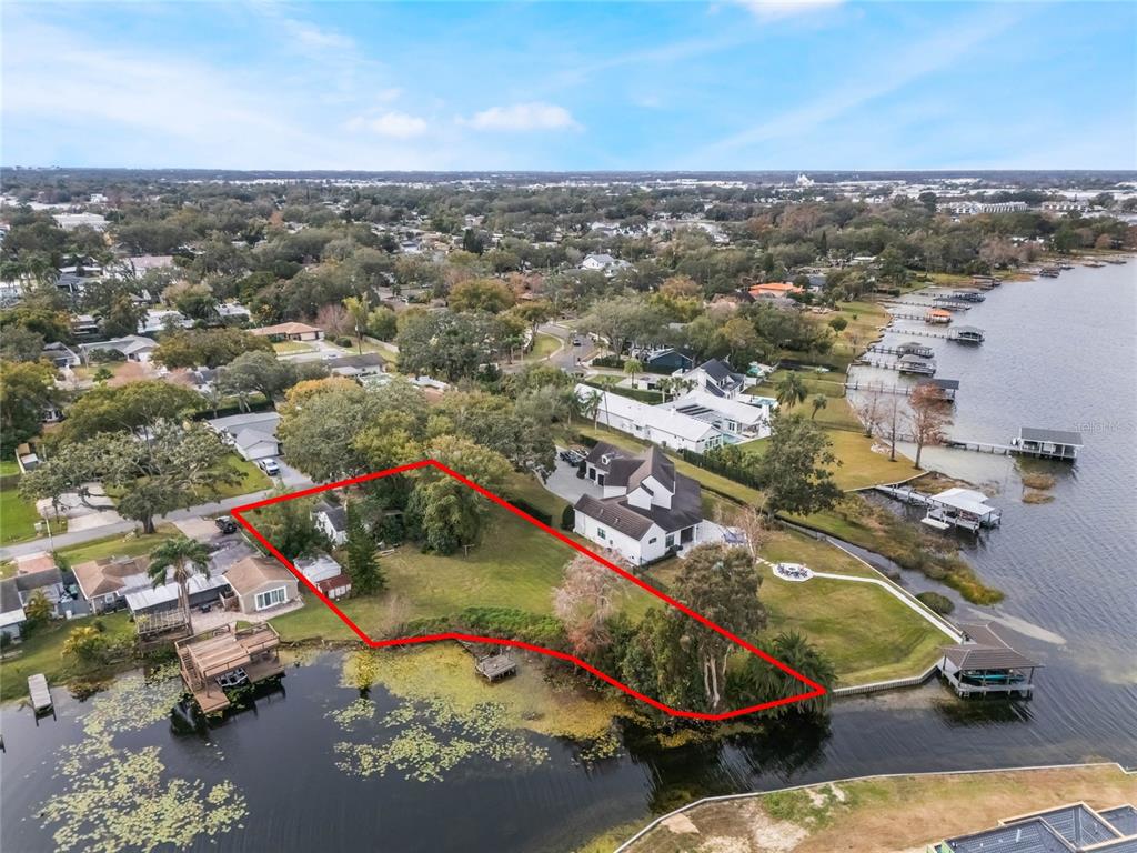 An aerial view shows a waterfront residential lot outlined in red with mature trees — 1113 VENETIAN AVENUE, ORLANDO, FL