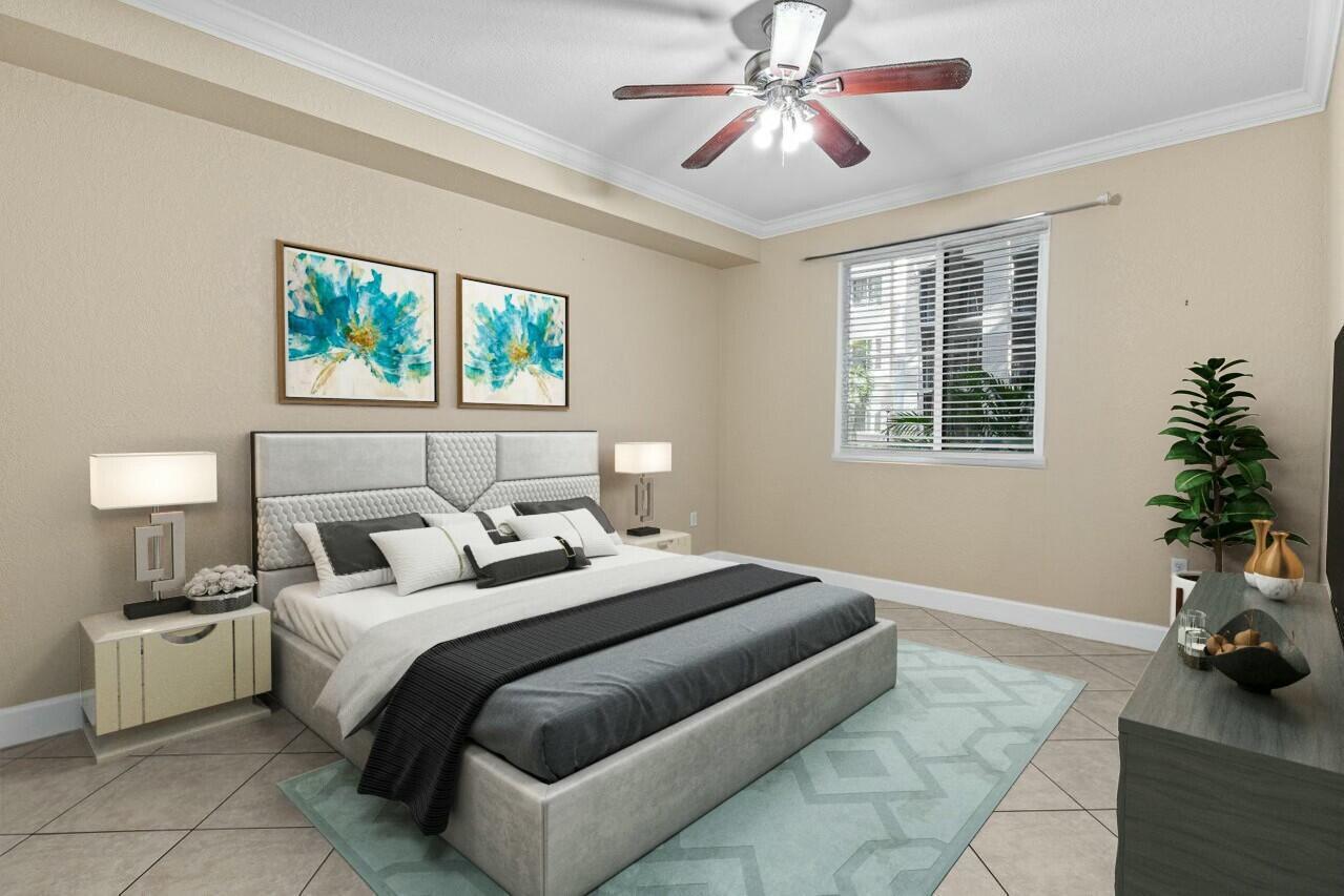 A bedroom features a gray upholstered bed, a ceiling fan, and a light blue rug — 1690 Renaissance Commons Boulevard # 1125, Boynton Beach FL 33426, BOYNTON BEACH, FL