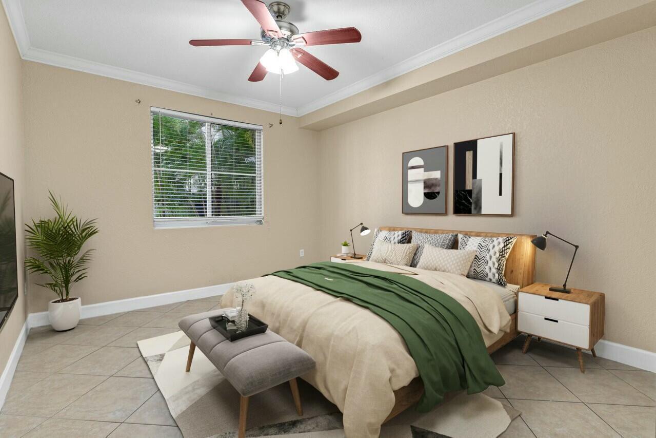 This bedroom features tile flooring, a ceiling fan, a bed with green bedding, and artwork — 1690 Renaissance Commons Boulevard # 1125, Boynton Beach FL 33426, BOYNTON BEACH, FL